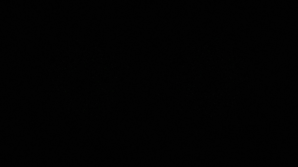 AshOrbit in silence, near-black, the visual at rest